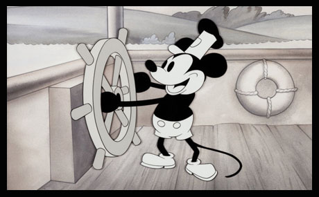 Animation cel from Steamboat Willie. A black-and-white Mickey Mouse cheerfully steers a boat down a river with a ship's wheel. Notably, Mickey is not wearing his iconic gloves.