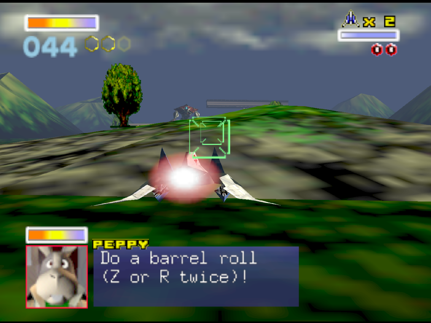 Screenshot from Star Fox 64. Fox's starfighter Arwing hovers in the center of the screen over a lush green landscape representing Corneria. In a dialogue box that takes up the bottom of the screen, rabbit wingman Peppy advises Fox to do a barrel roll by pressing Z or R twice.