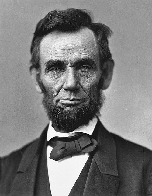 1863 photo of Abraham Lincoln. The iconic black-and-white photograph features Lincoln staring directly at the camera. The texture of his skin looks strangely overemphasized, typical of many photos from the 1860s.